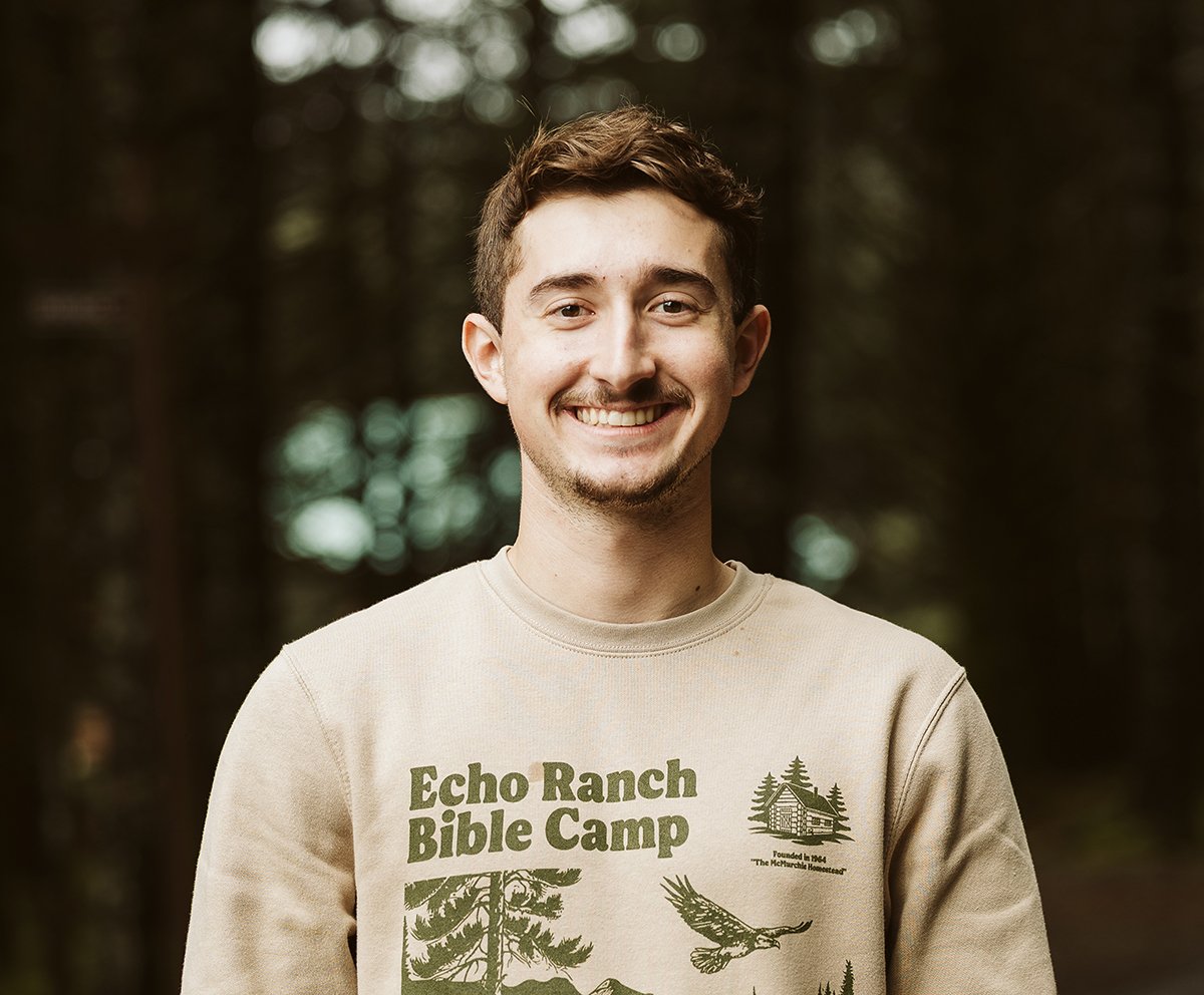 Evan smiling wearing an Echo Ranch Bible Camp sweatshirt.